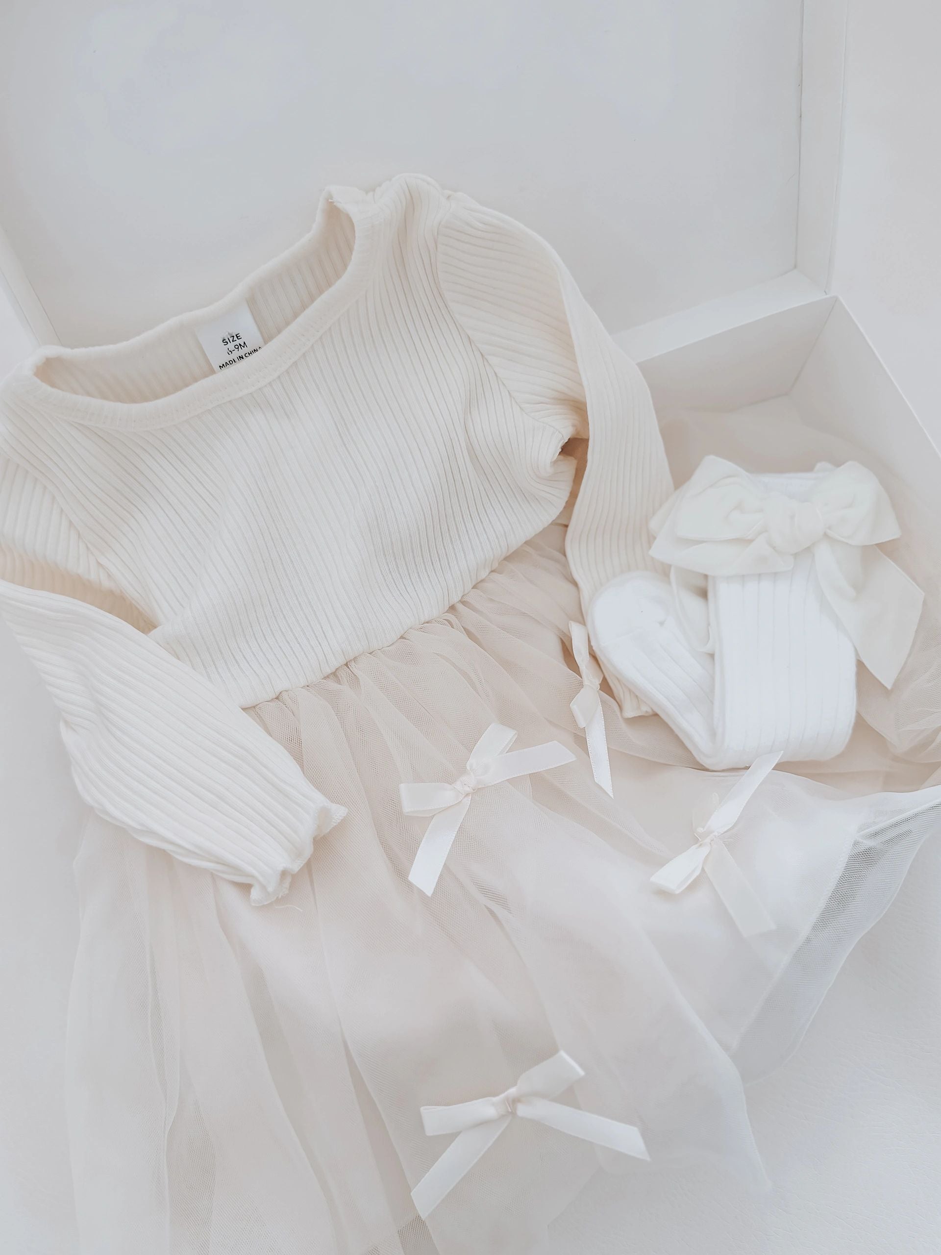 The Snug Baby Company long sleeve baby doll tulle dress with 3D bows